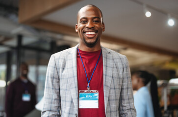 Portrait of a young businessman with an id badge attending a networking event