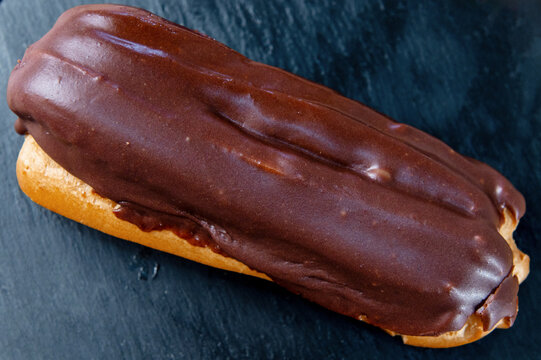 French ecler with chocolate. Traditional french dessert eclair.