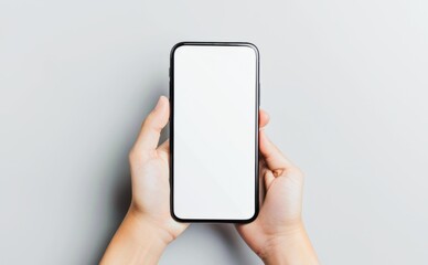 Person Holding Smartphone With Blank Screen Over Gray Background