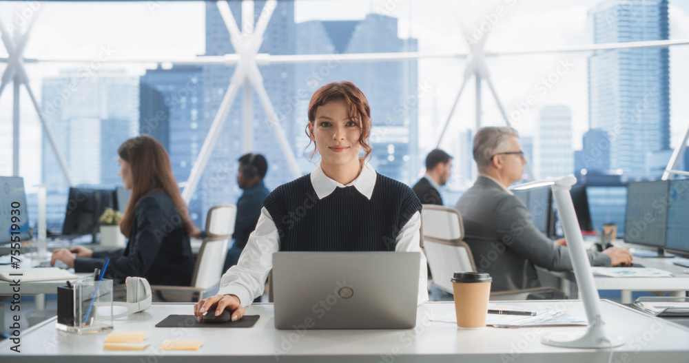 Aufkleber beautiful caucasian woman working on laptop computer in bright office in urban skyscraper office in 