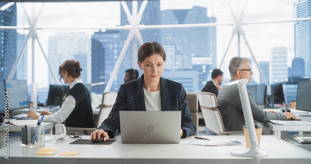 Fototapete professional female business development manager typing on laptop computer in bright skyscraper offi