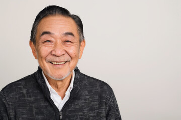 Portrait of old healthy, cheerful handsome Asian senior man smiling and looking at camera with white background. Happy aging society, retirement, teeth, health and senior healthcare concept