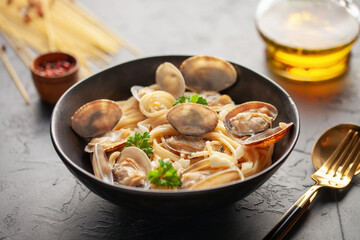 Seafood pasta with clams. Spaghetti alle Vongole on a light background.