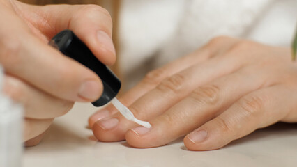 Obraz na płótnie Canvas Applying nail polish to the nail. Close-up of a nail brush. Manicure. Beauty care