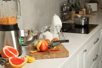 Modern mixer, blender and different ingredients on white marble countertop in kitchen, space for text