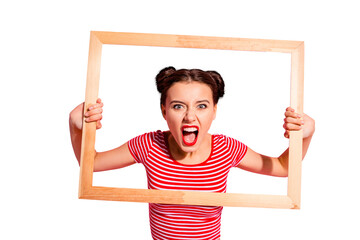 Portrait of her she nice cute charming attractive glamorous aggressive girl in striped t-shirt holding in hands wooden frame trying to break rules borders life lifestyle isolated over pink background