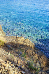 Beach, crystal clear water in Mediterranean sea near to cliff. Cirali, Antalya Province in Turkey.
