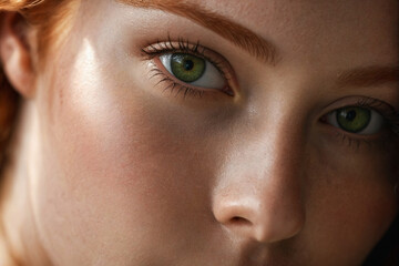 Close-up portrait of redhead model with green eyes