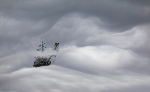 Sailing old ship flying over the stormy clouds