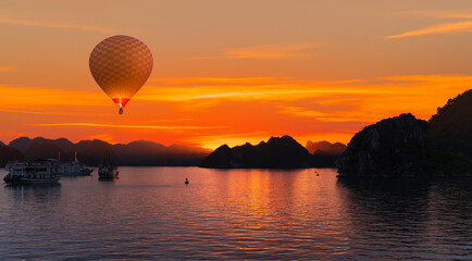 Hot air balloon flying over harbour In Ha long Bay at sunset - Vietnam