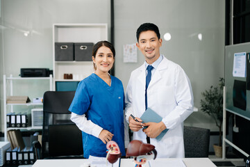 Obraz premium Successful team of medical doctors looking at camera and smiling while standin. Health, professional and people team in hospital