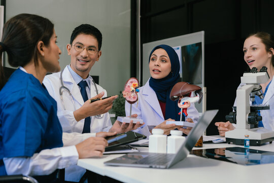 Medical, meeting and laptop for team in office in discussion, brainstorming and planning. Doctor, nurse and computer on desk, teamwork or workshop for data analytics.