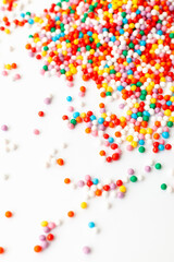 Colorful confectionery sprinkles on white background. Decoration for cake and bakery.