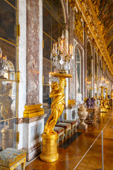 Hall of Mirrors. Decorated interior with historical furniture and architectural details of Chateau Versailles near Paris, France - 755545516