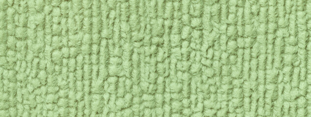 Light green fluffy background of soft, fleecy cloth. Texture of olive textile backdrop with pattern, macro.