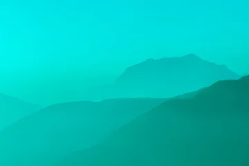 Crédence de cuisine en verre imprimé Turquoise Spectacular mountain ranges silhouettes in shades of light blue.
