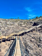 Hiking wooden boardwalk in mountains, hiking trail, wooden stairs