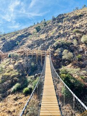 Fototapeta na wymiar Hiking wooden boardwalk in mountains, hiking trail, wooden stairs