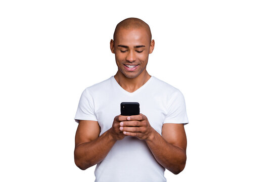 Close up photo strong healthy dark skin he him his macho bald head telephone arms reader foreign pen-friend exciting amazing communication wearing white t-shirt outfit clothes isolated grey background