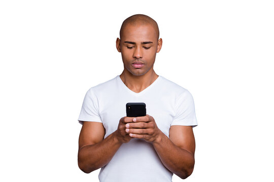 Close up photo strong healthy dark skin he him his macho bald head telephone arms reader not smiling looking political sports news wearing white t-shirt outfit clothes isolated grey background