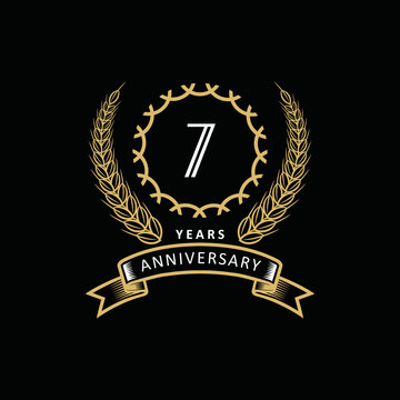 7st anniversary logo with gold and white frame and color. on black background