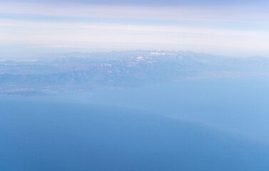 Fototapeta na wymiar Plane Window View, Aircraft Fly Landscape, Looking from Plane Cabin, Plane Window Aerial View