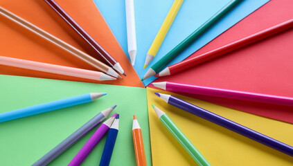 Fototapeta premium Lot of sharp wooden pencils lying on multicolored background closeup. Art class at school concept