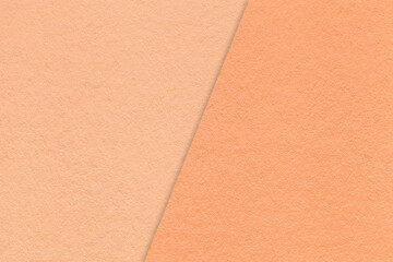 Texture of craft peach fuzz paper background, half two colors, macro. Vintage kraft coral cardboard.