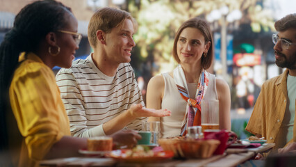 Two Diverse Couples Spending Time Together on a Double Date, Enjoying Delicious Food at an Outdoors Pizzeria. Multiethnic Young Men and Women Having Joyful Conversations, Smile and Laugh at Jokes