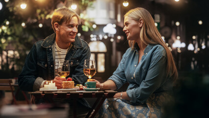 Young Man and Woman Meeting at a Restaurant, Having a Carefree Evening Date on a Terrace. Handsome...