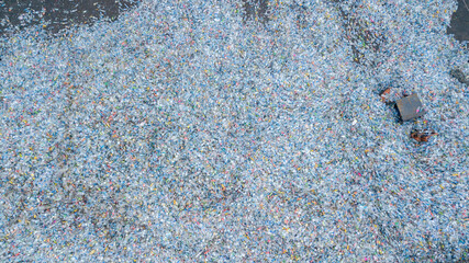 Aerial view plenty of plastic bottles, Waste plastic bottles other types of plastic waste at the waste disposal site, plastic bottles at the factory for processing and recycling PET recycling plant.
