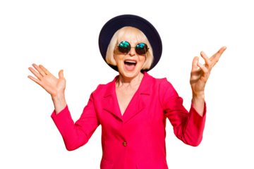 Party on! Portrait of wondered and happy old lady in hat and red jacket isolated on yellow background