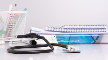 close-up black stethoscope - medical tool for health on gray background with copy space