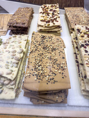  large bar of chocolate with nuts and almonds in shop