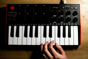 Close-Up a  woman hands playing on piano MIDI keyboard
