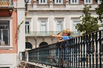 Young travelers at Lisbon viewpoint pointing with fingers - 755576530