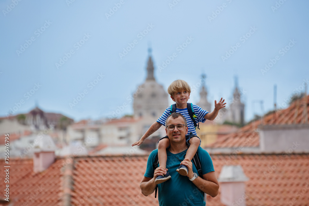 Wall mural joyous kid on fathers shoulder at lisbon viewpoint, portugal