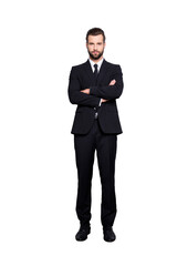 Full size fullbody portrait of  virile harsh business person in black suit with tie having his arms crossed, isolated on grey background