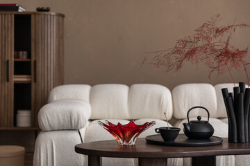 Creative compositions of living room interior with boucle sofa, wooden commode, coffee table, tea...