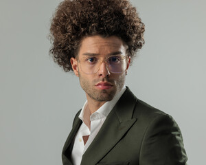 portrait of handsome young businessman with glasses looking forward