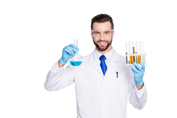 Portrait of cheerful handsome scientist with bristle in white lab coat, tie, protective glasses having test tubes and flask with multi-colored liquid, looking at camera over grey background