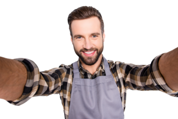 Self portrait of trendy stylish baker with hairstyle shooting selfie on smart phone with two hands, isolated on grey background, having video-call during break pause timeout