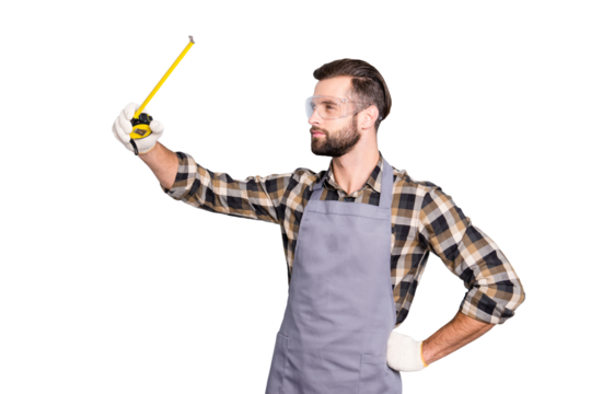 Portrait of thoughtful busy carpenter with tape-line, roulette holding hand on waist, measuring checking, isolated over grey background