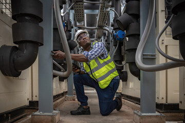 Industrial engineer check the air conditioning cooling system on site. engineer visit and inspection site engineer at industrial site. Inspector engineer check and working on site