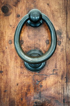 Ornate Antique Door Knocker on Weathered Wood