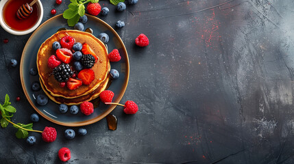 Healthy summer breakfast, homemade classic American pancakes with fresh berries and honey, dark concrete background