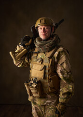 portrait of an airsoft soldier with camouflage clothing and a rifle with a telescopic sight