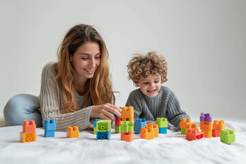 Obraz na płótnie Canvas mother and ADHD son playing with blocks