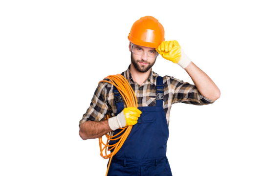 Portrait of virile harsh electrician with bristle in overall, shirt, having rolled cable on shoulder, holding hand on hardhat, standing over grey background