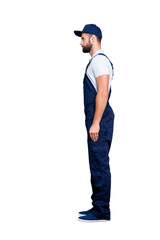 Full size body profile portrait, snap of attractive, confident deliver in blue uniform with stubble, isolated on grey background © deagreez